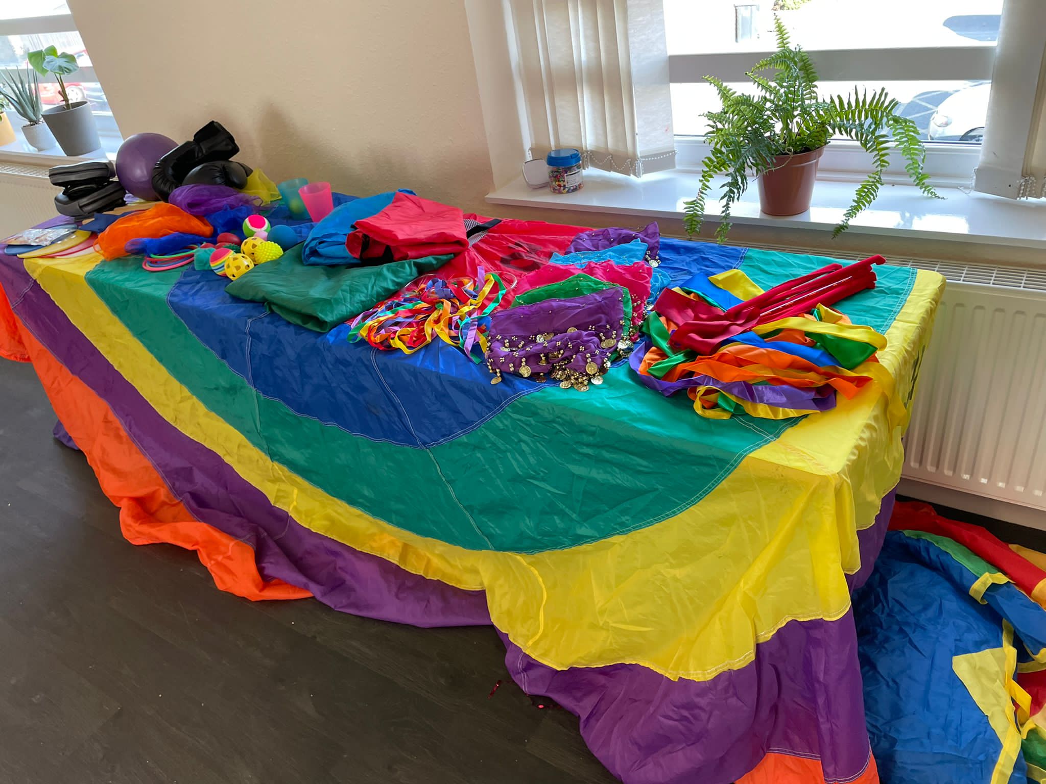 A table of multi-coloured flags and streamers.