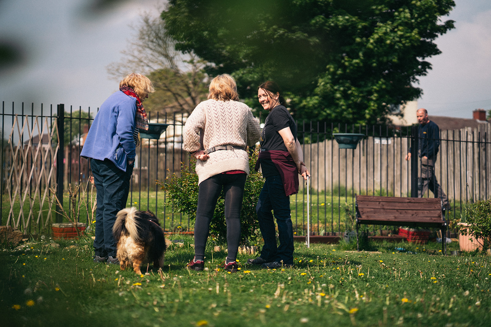 Three ladies stood talking in a community garden space