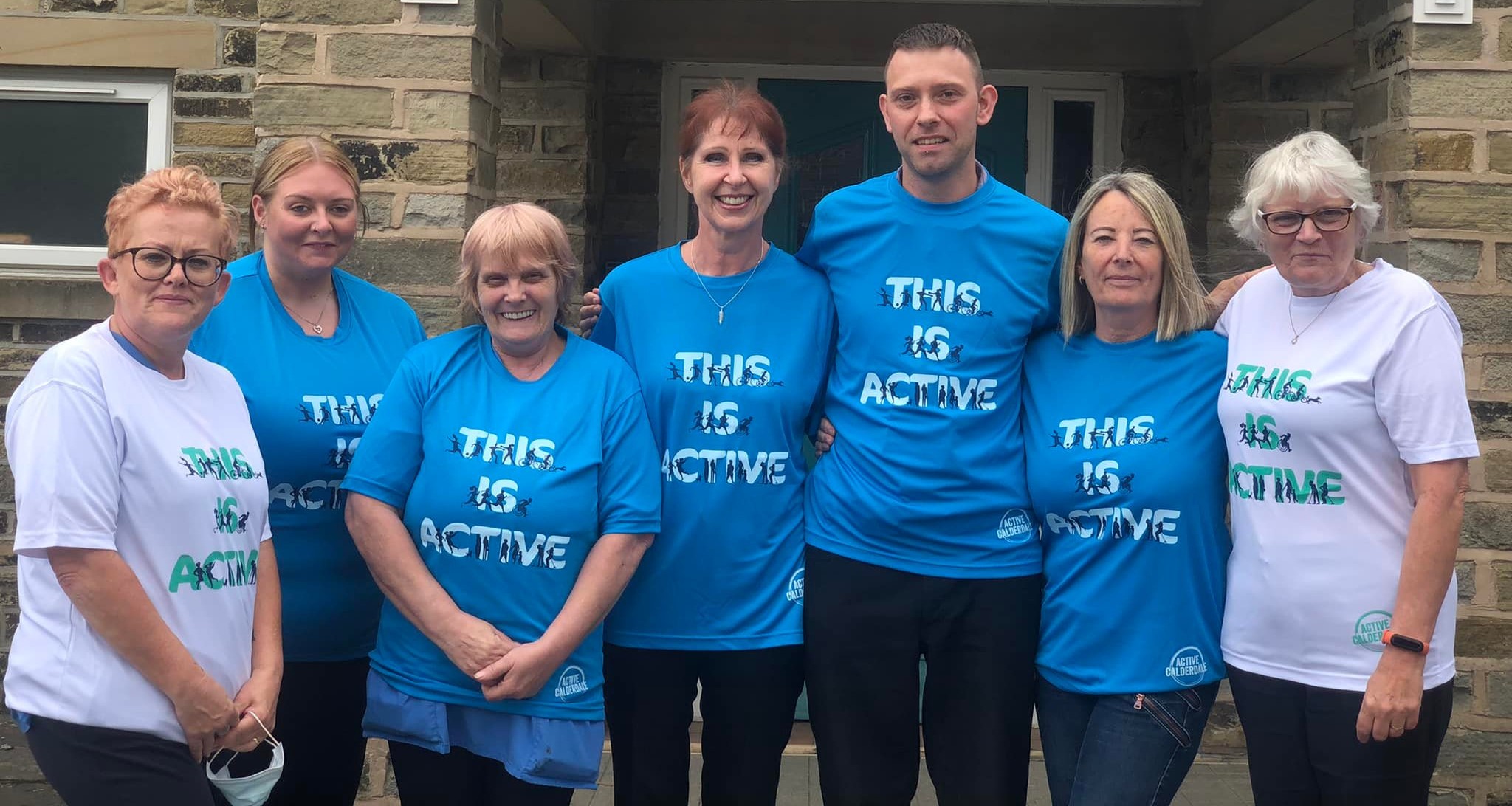 Seven members of staff from St Winifred's Nursing Home, stood outside wearing 'This is Active' t-shirts.
